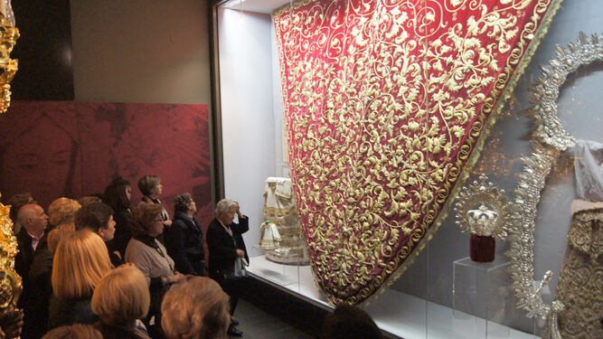 Varios visitantes contemplan una de las vitrinas del museo