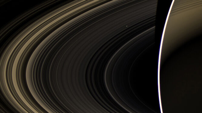 Venus, como una mota de  polvo, visto a través de  los  anillos de  Saturno  en foto del telescopio espacial Cassini.