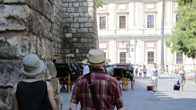 Dos turistas pasean por Sevilla.