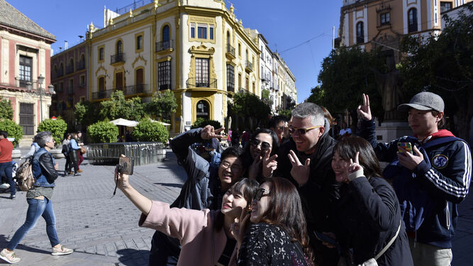 Turistas asiáticos disfrutan del sol en Sevilla en el puente de diciembre.
