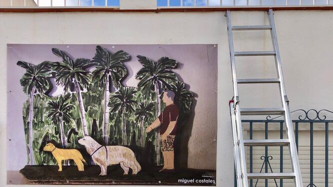 Una pintura de Miguel Costales ayer durante el proceso de instalación de la lona.