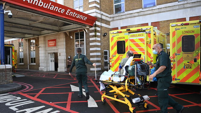 Ambulancias del NHS aguardan en la entrada de un hospital londinense.