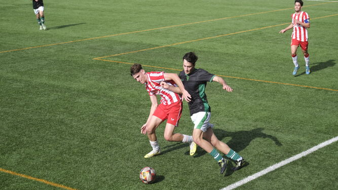 Un jugador rojiblanco pelea por un balón con un rival durante el encuentro de la pasada jornada.